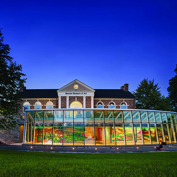 Berman Museum of Art as the sun sets and the sky lights up bright and dark blue.