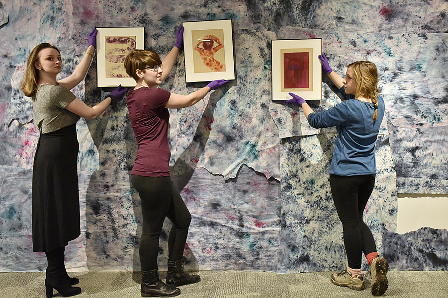 Curate Museum Studies consider installations for a past exhibit.