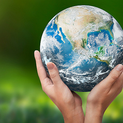Hands raised to Earth. climate change