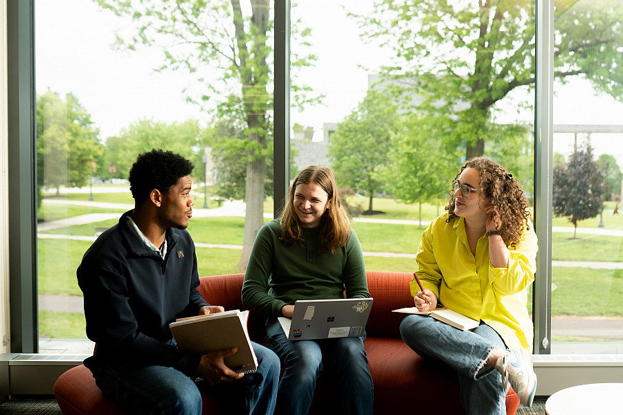 3 students talking in IDC lounge