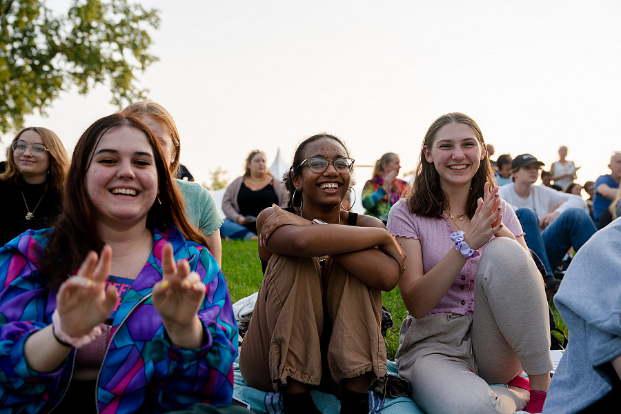 Students enjoying a performance on the Berman Museum lawn's amphitheater at a event sponsored by the Radiance Peer Connection Program, a ...