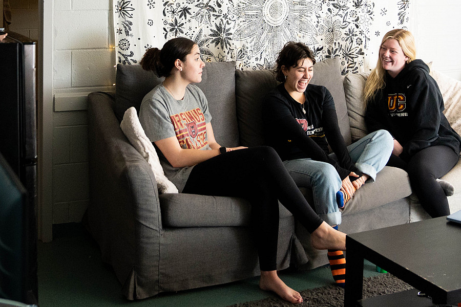 Students hang out in a common room of Reimert Hall, a suite-style living community with an open courtyard in the center.