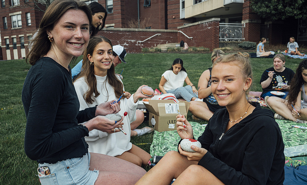 Students gather to paint rocks as part of an Residence Life event.