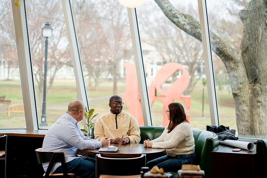 ISS staff member meets 2 students over coffee to talk academic strategies and support needs